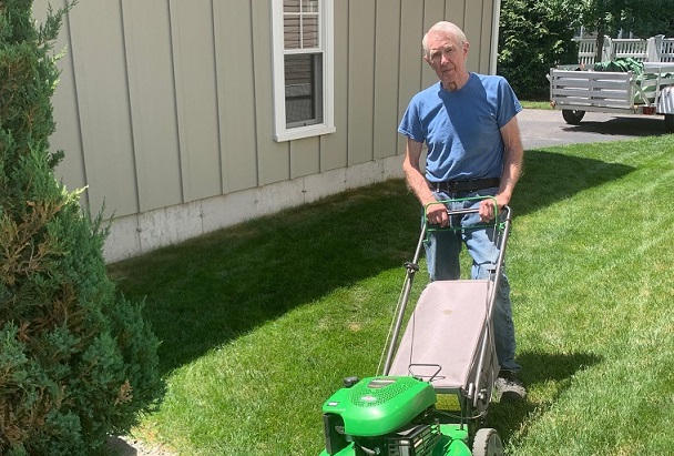 Older man mowing his lawn