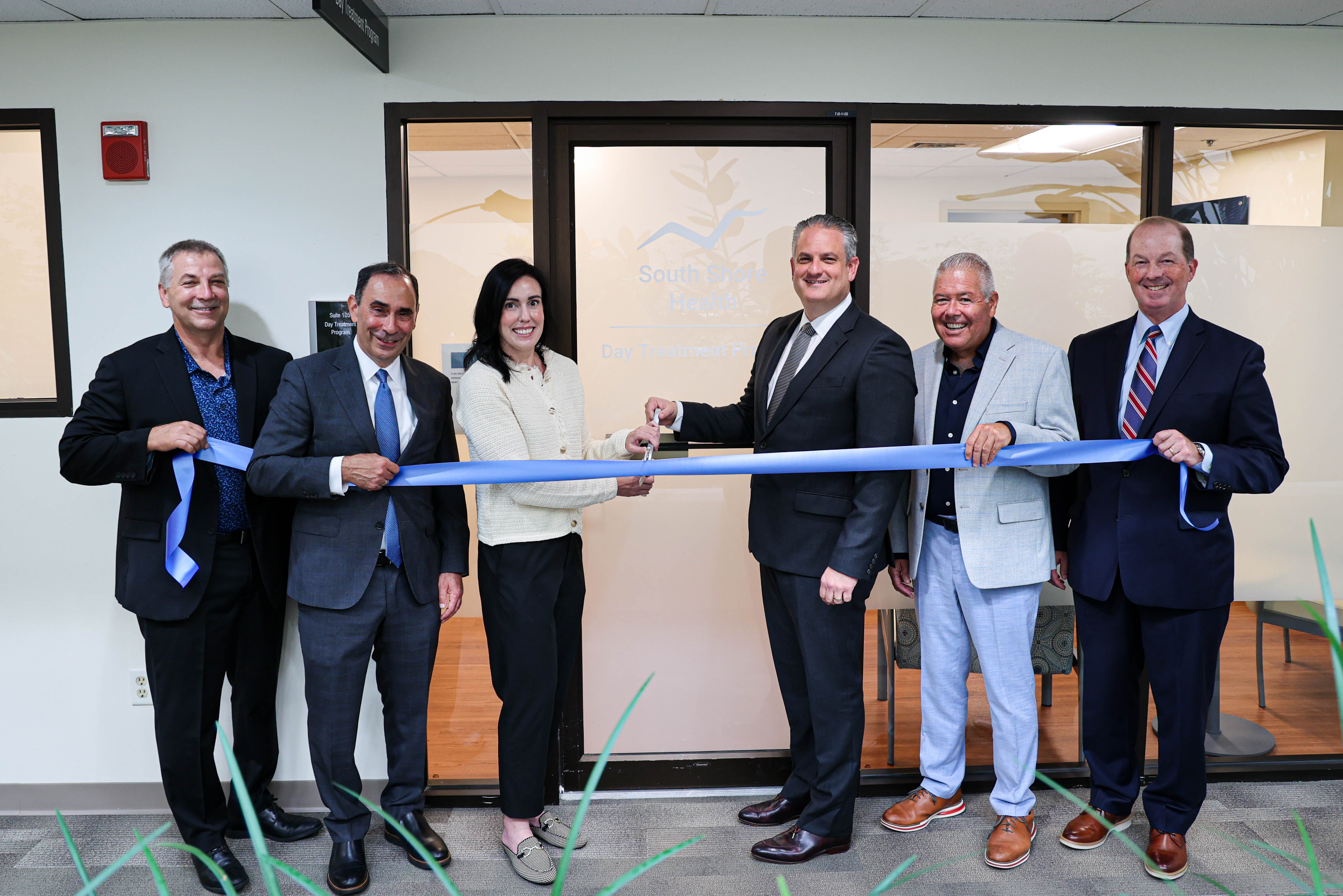 Group photo of leaders from South Shore Health, Aspire, and the Town of Weymouth pose for a photo at the Day Treatment Program ribbon cutting.