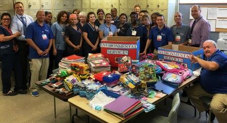 Team of volunteers surrounding table with donations