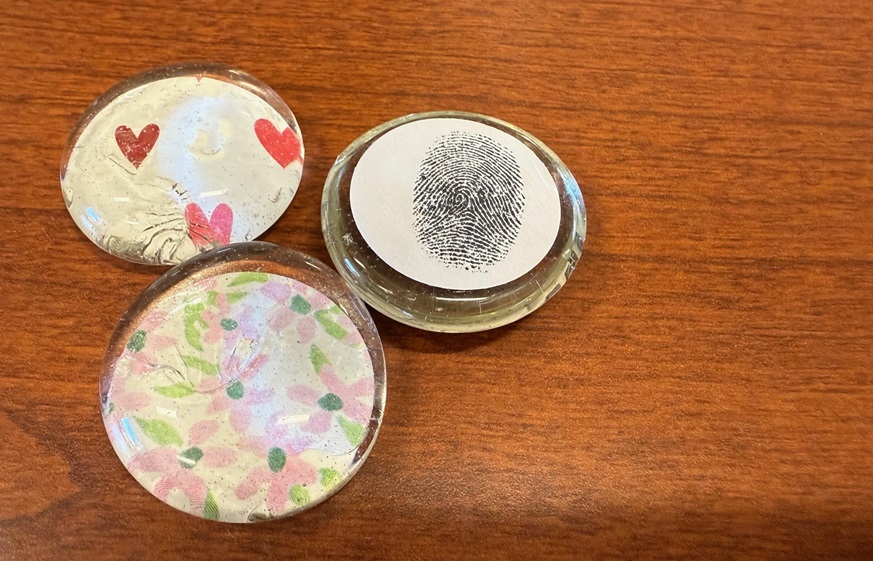 Glass fingerprint tokens made by the Palliative Care Team