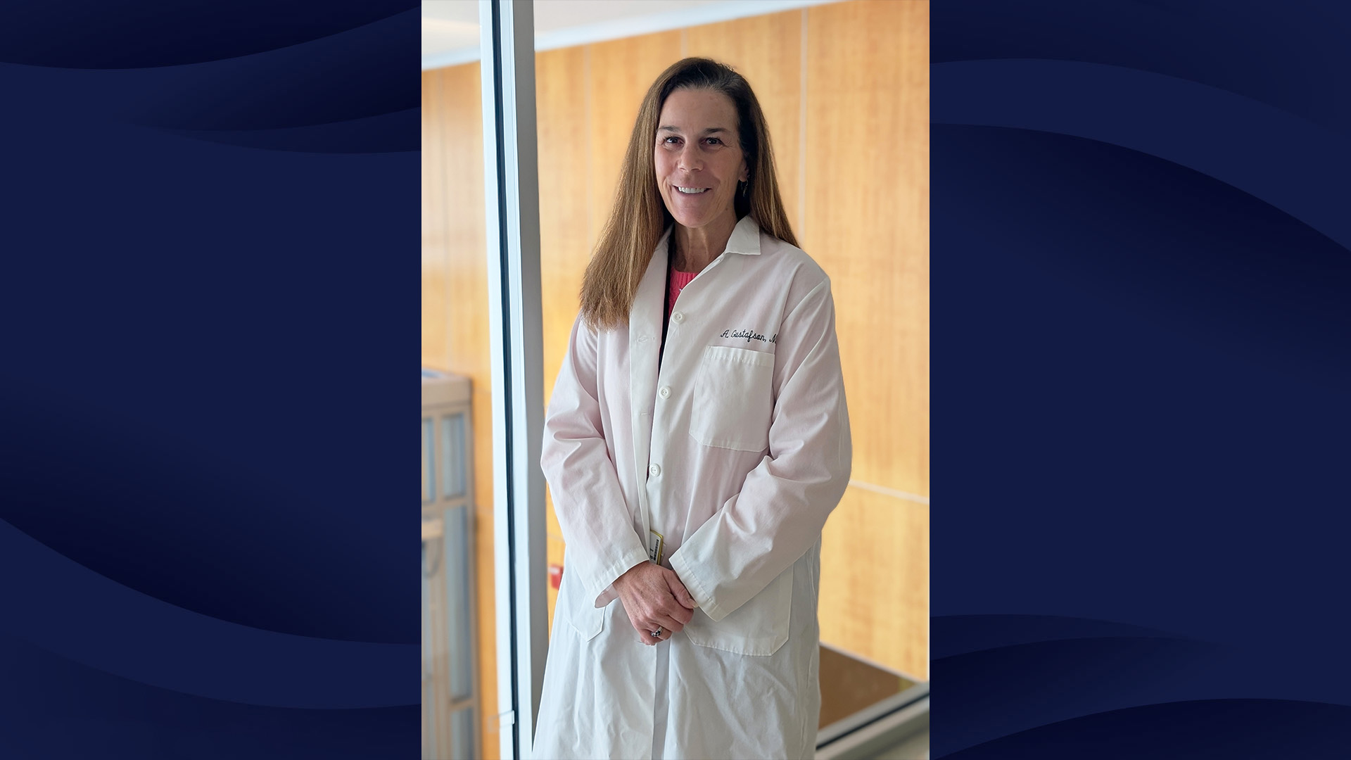 Photo of Alison Gustafson, MD of South Shore Health wearing a white lab coat. Photo is on a navy, wave-patterned background.