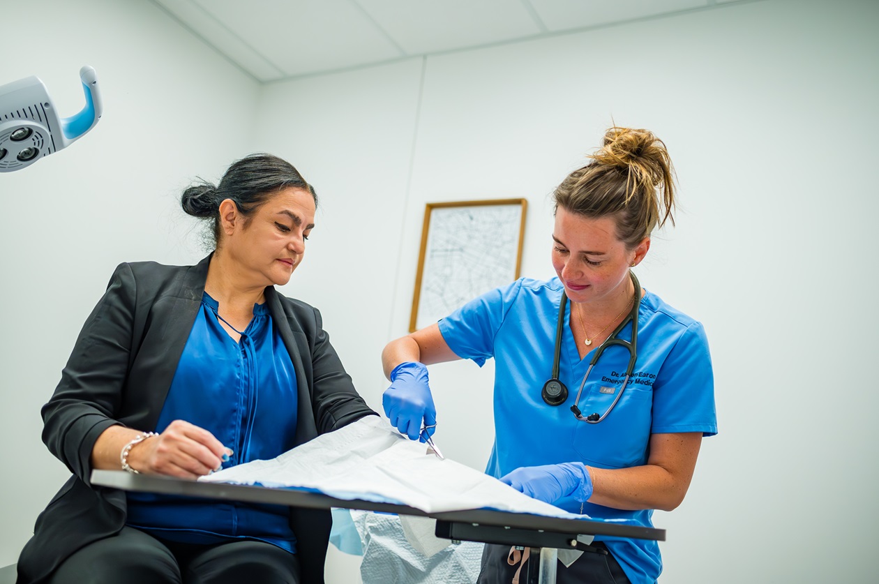 A female patient gets stitches from an urgent care provider