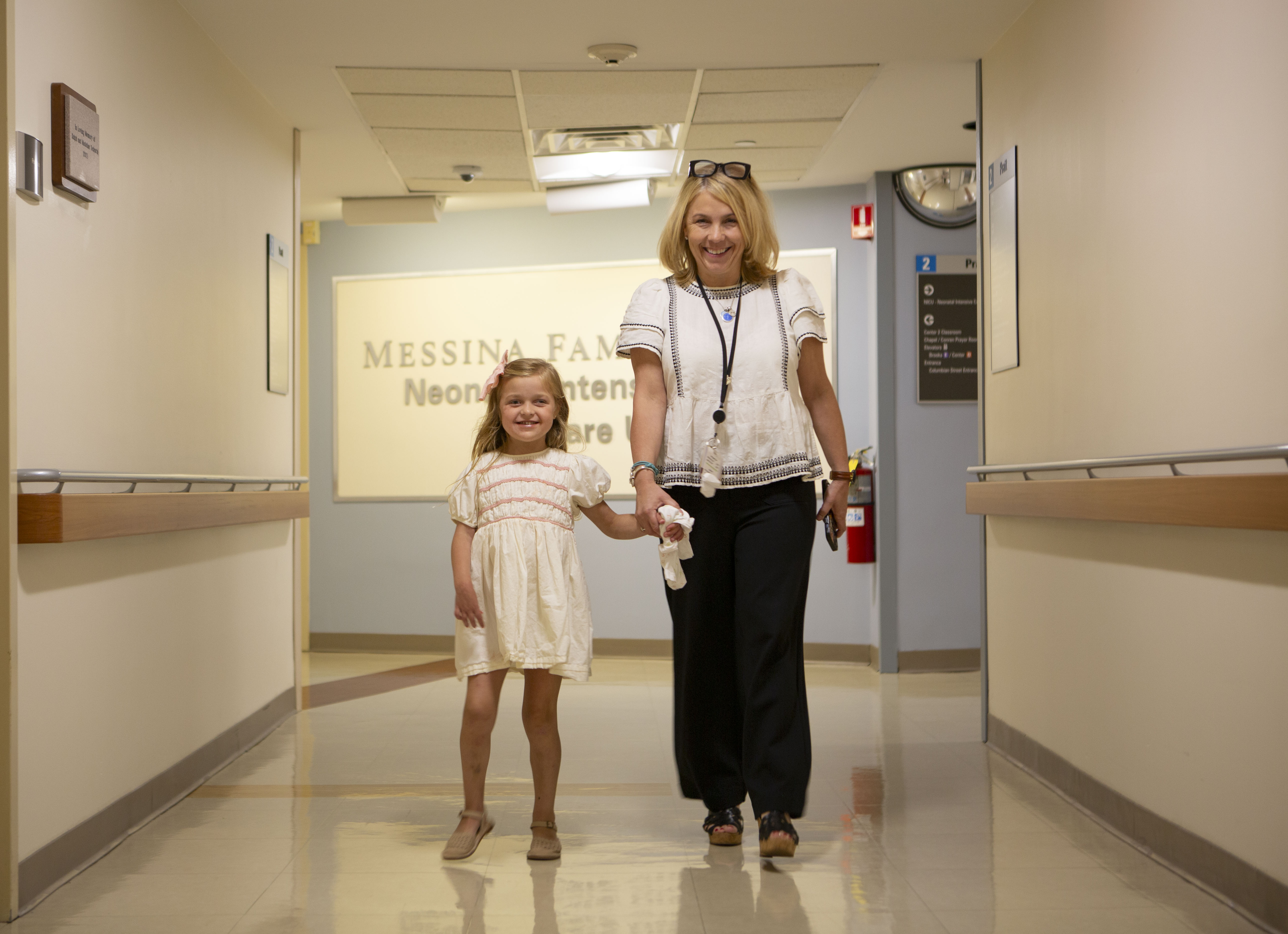 Georgia Bowen and Beth Brooks walk down the hallway of South Shore Hospital