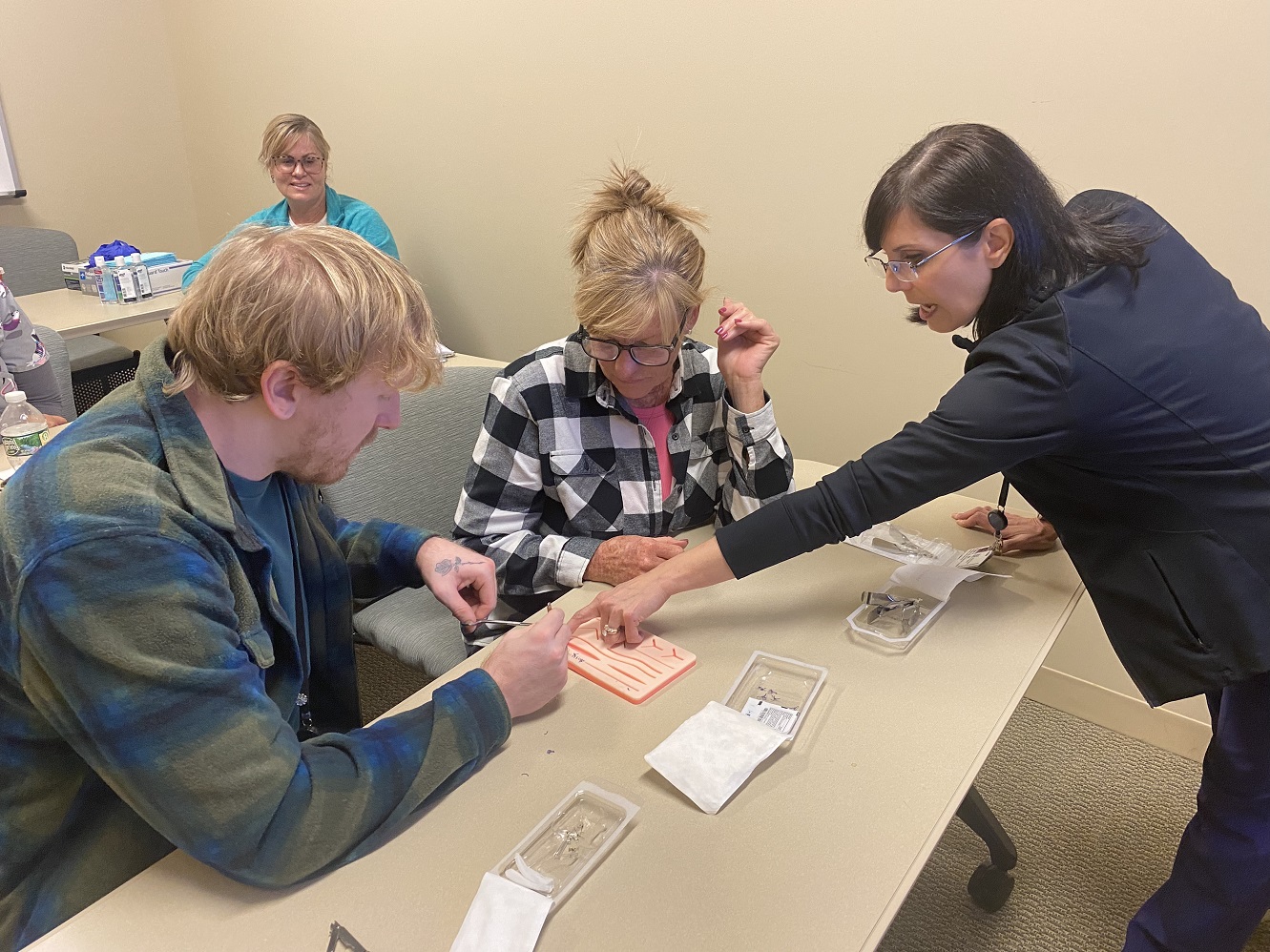 Elisa of South Shore VNA demonstrates a care technique during a class in the VNA sim lab