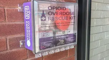 Photo of a SAMBOX Opioid Overdose Rescue kit mounted on the wall of the Grayken Center for Treatment at South Shore Health