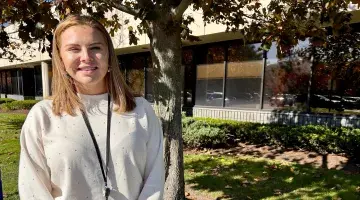 Female social worker posing outside of an office building
