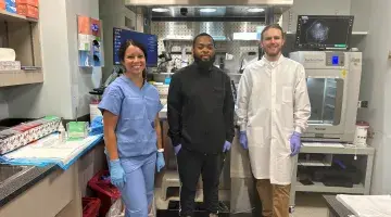 Lab colleagues stand in front of one of the new grossing stations