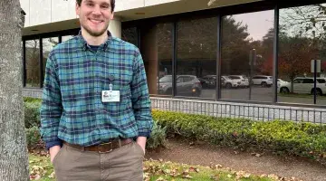 Colin O'Donnell, an occupational therapist poses for a photo outside the VNA offices