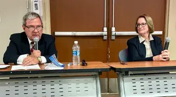 Dr. Michael Hession at the microphone speaking