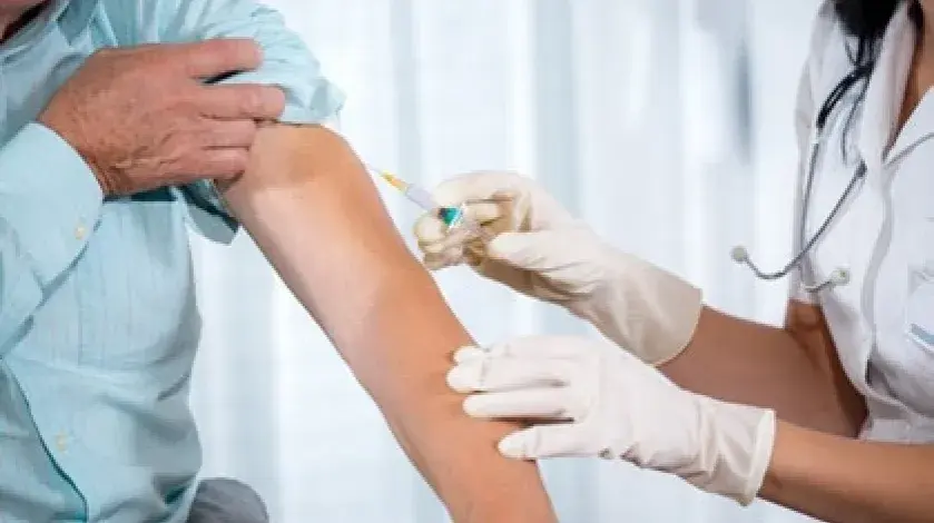 A male patient receives a vaccine