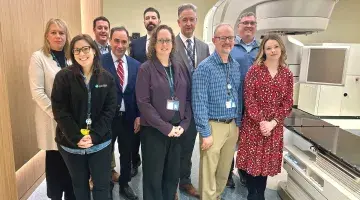 Colleagues from the Dana-Farber Brigham Cancer Center at South Shore Health pose next to the new Varian TrueBeam Linear Accelerator machine