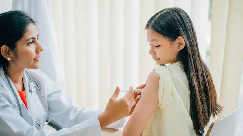 A doctor administers an HPV vaccine to a young girl