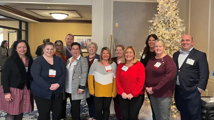 Several nurse leader colleagues pose for a photo at a December 2023 Organization of Nurse Leaders meeting.