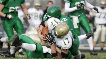 A football player is tackled during a game