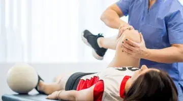 A provider evaluates the knee of an injured athlete