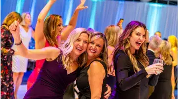 Woman dancing at the Moonlight & Miracles Gala