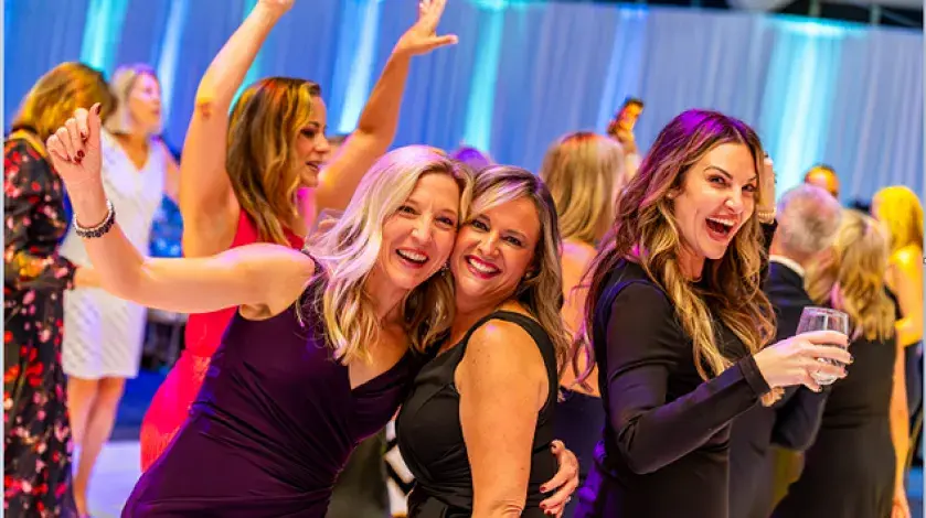 Woman dancing at the Moonlight & Miracles Gala