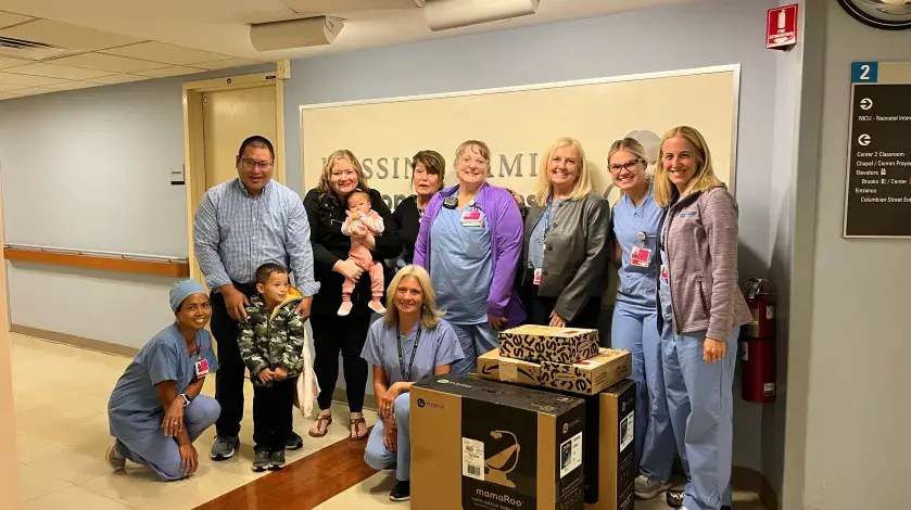 The Leong Family poses for a group photo with nurses and doctors from the South Shore Hospital NICU and their donated items.